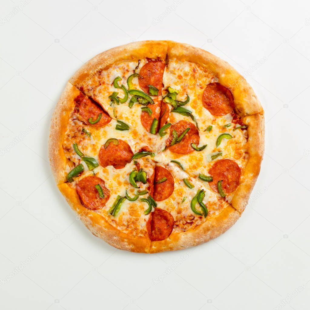 Sliced delicious fresh pizza with pepperoni and cheese on a white plate. Top view with copy space for text. Flat lay