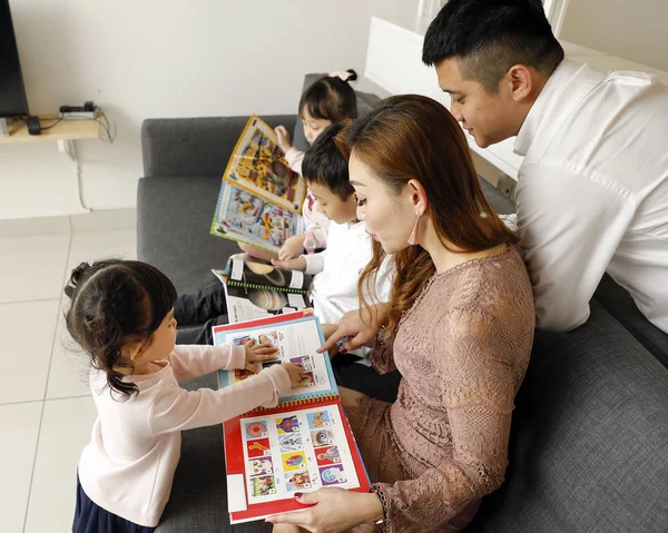 Rodzice Dziecko Rodzina ojciec matka córka syn siedzieć na kanapie czytać — Zdjęcie stockowe