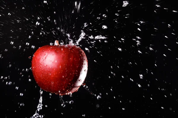 Apple in water on black background — Stock Photo, Image