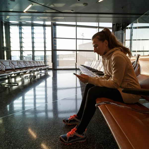 Woman in airport hall. Woman waiting her flight at airport termi
