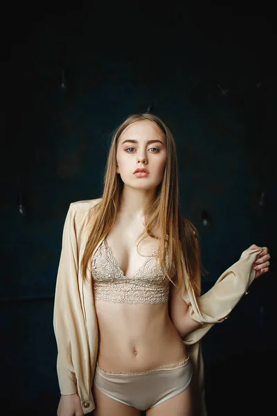 Young sexy woman in a beautiful handmade cream lingerie. — Stock Photo, Image