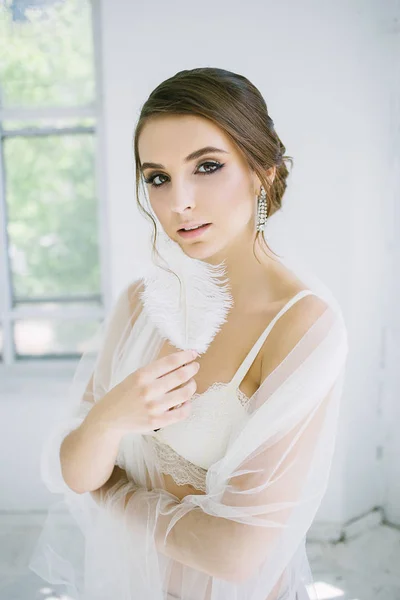 Bride with feathers in hand — Stock Photo, Image