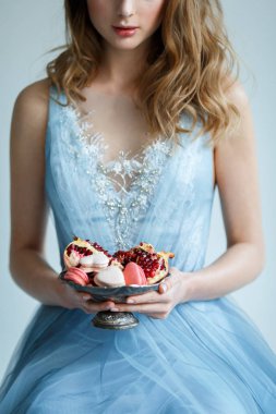 Macaroons ve antik bir kabın içinde nar