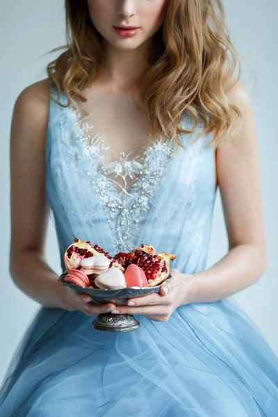 Macaroons ve antik bir kabın içinde nar