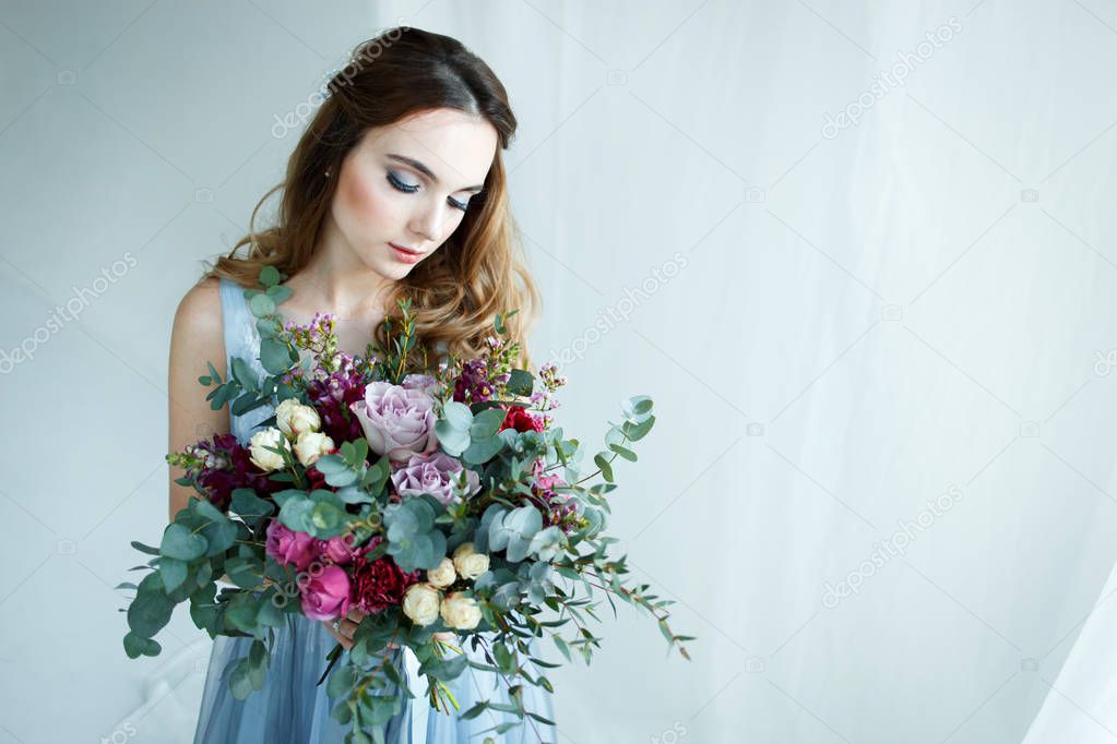 bride in an blue gown with bouquet
