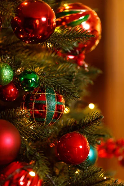 Schöne rote Weihnachtskugeln, die am Ast des Weihnachtsbaums hängen — Stockfoto