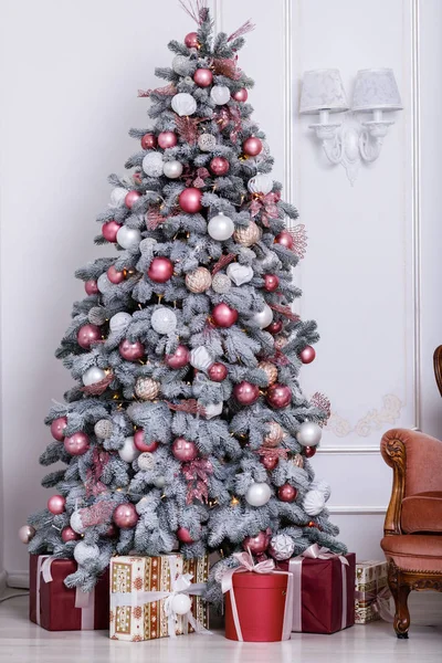 Mooie kerstboom versierd met speelgoed en geschenkdozen — Stockfoto