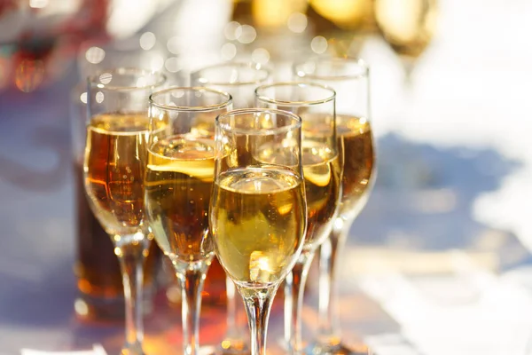 Glasses of champagne and sparkling wine served at charity event, alcoholic drinks close-up.