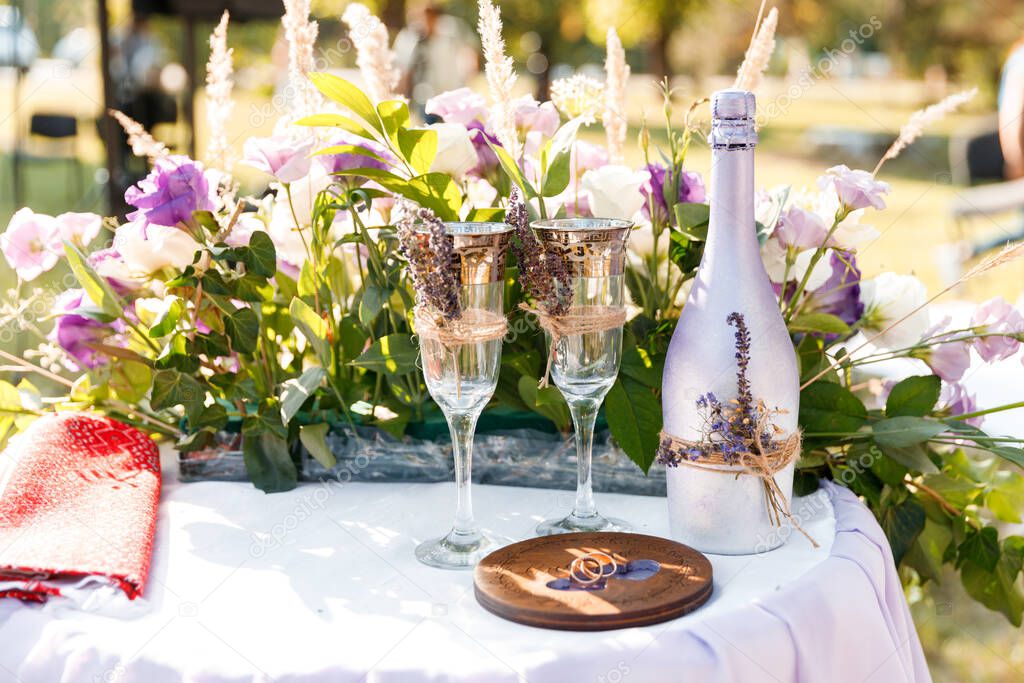 Glasses with champagne on the table for the bride and groom at the engagement ceremony