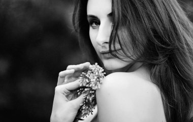 Bahar leylak bahçesinde duran genç güzel kızın romantik siyah beyaz portresi..