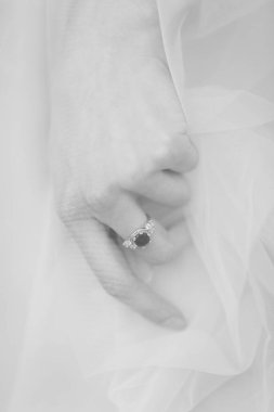 Gelinin eli uzun peçenin altında beyaz altın nişan yüzüğüyle