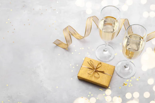 Twee glazen Champagne en gouden geschenkdoos — Stockfoto