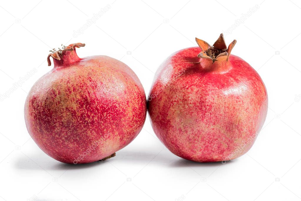 Two pomegranates isolated on a white background