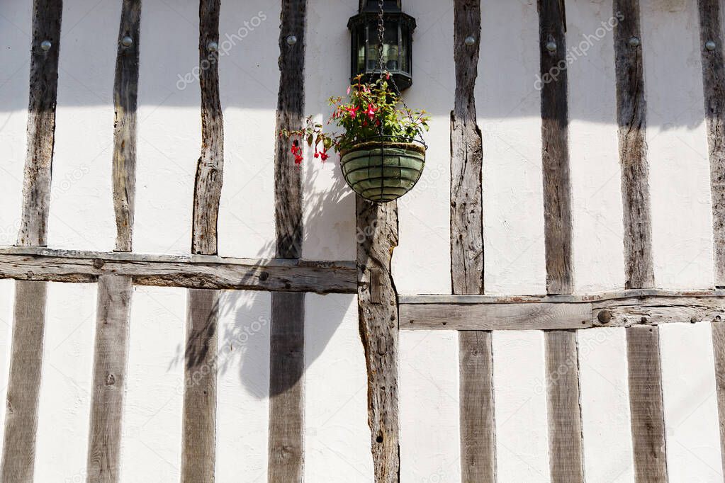 countryside street wall with flowers , wooden bars in traditional British style