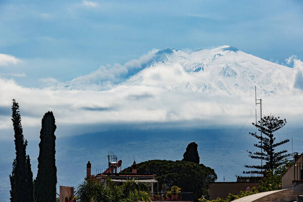 snow covered volcano Etna during abnormally cold spring, Taormina, Sicily