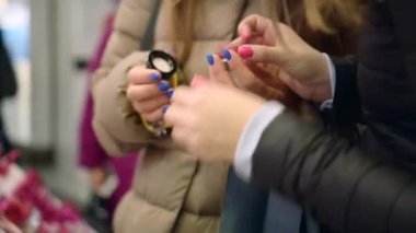 Güzel genç kadınlar dudaklarında parmaklarıyla yeni ruj rengini deniyorlar.