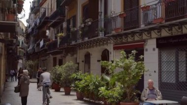 Yavaş ölçülen yaşam. Konforlu sokaklar, bisikletçiler, yayalar, adam kafede oturuyor.