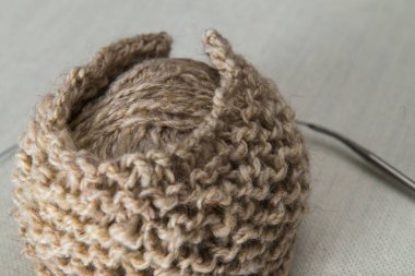 Örgü, iplik iğne ile bej renkli topları örnek