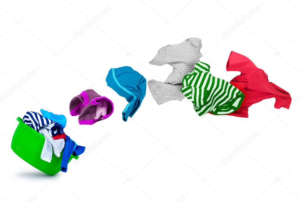 bright colorful clothes flying out from wash bowl on white