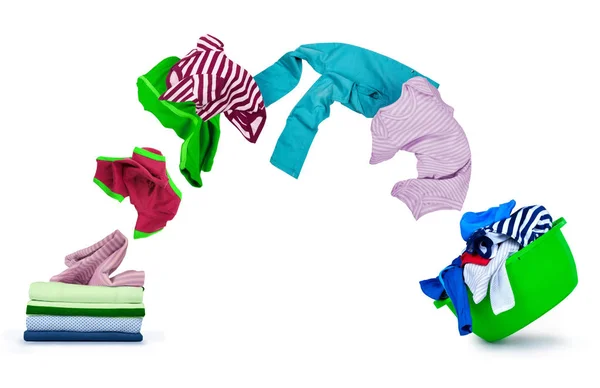 Kläder flyga ur högen och falla på tvätt skål isolerad på vit — Stockfoto