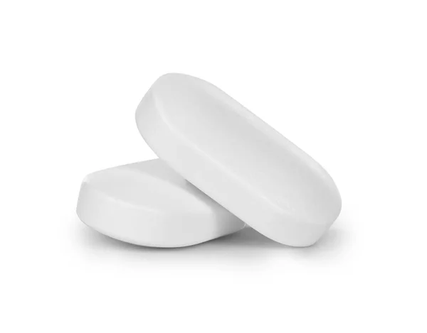 Primo piano di due pillole isolate su sfondo bianco — Foto Stock