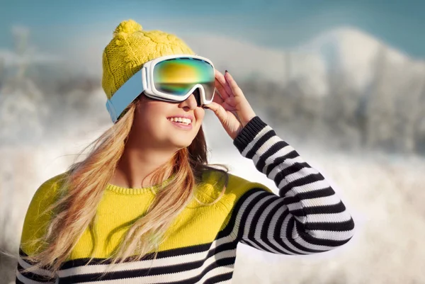 Menina feliz em uma máscara para snowboard contra o pano de fundo do sn — Fotografia de Stock
