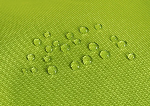 Zielony, wodoodporny materiał z waterdrops — Zdjęcie stockowe