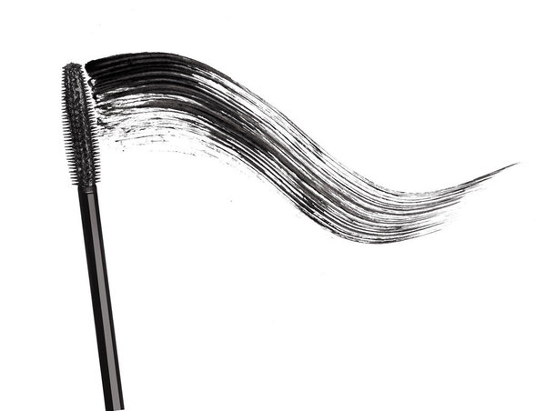 Stroke of black mascara with applicator brush close-up, isolated