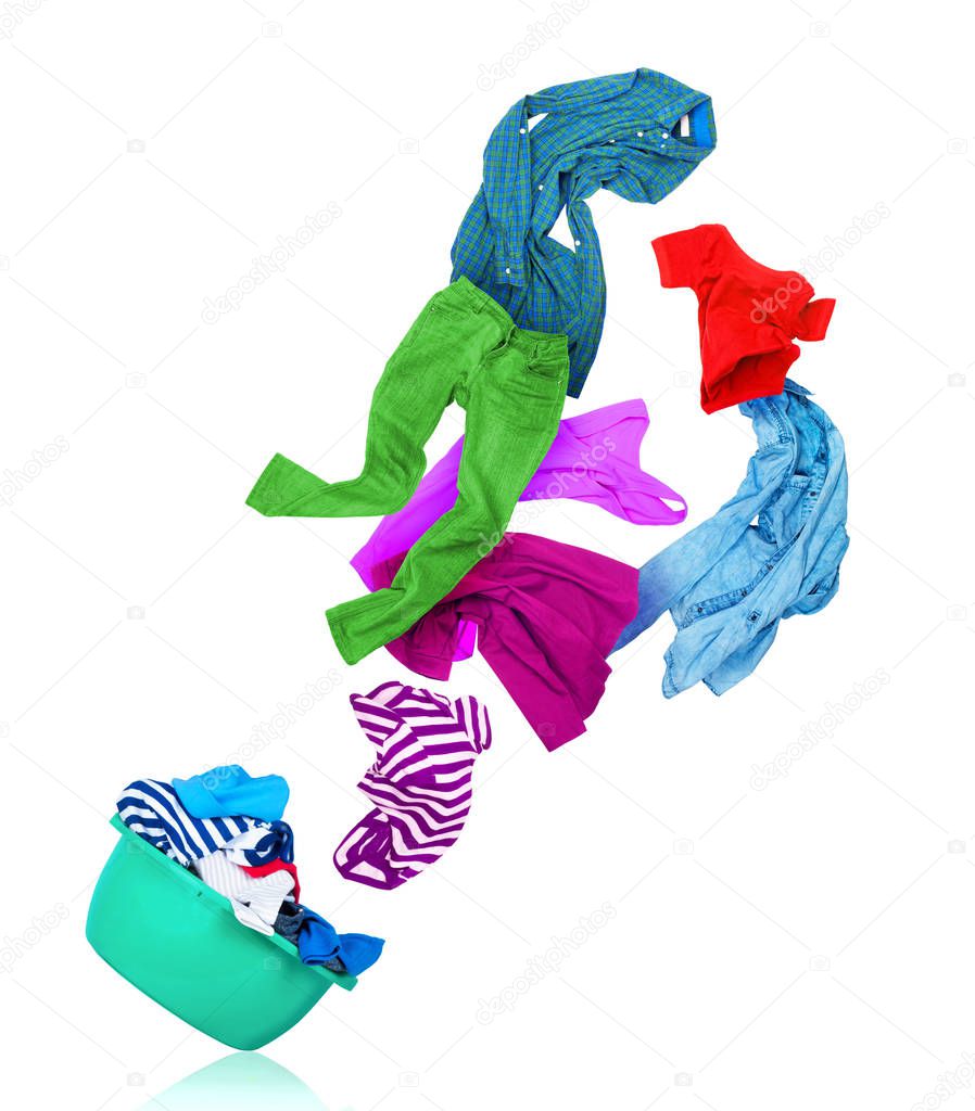 bright colorful clothes flying out from wash bowl on white backg
