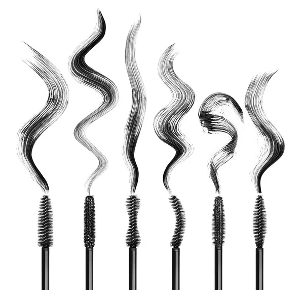 Set of various mascara brushes with strokes on white — Stock Photo, Image