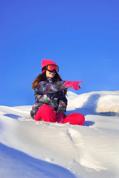 Šťastná dívka sedí na vrcholu zasněžené hory — Stock fotografie