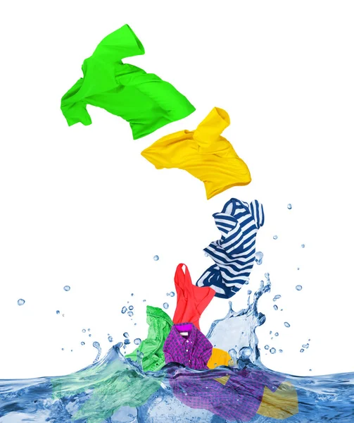 Colorful clothes fly out of the water, isolated on white backgro — Stock Photo, Image