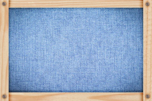 Denim fabric in a wooden frame — Stock Photo, Image