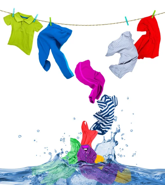 Colorful clothes fly out of the water, isolated on white