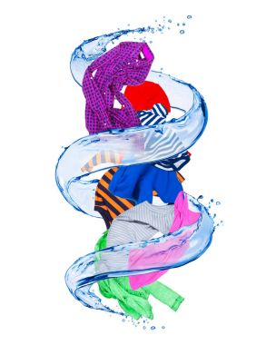 Colorful clothes rotates in a swirl of water on white background clipart