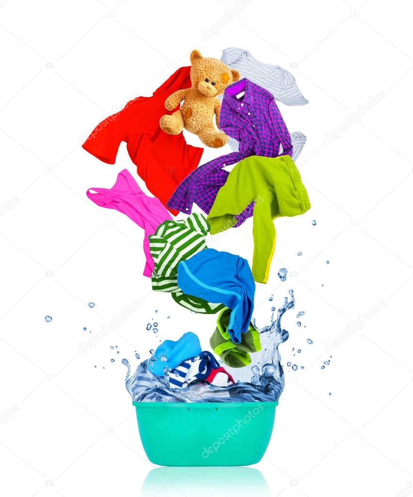 Colorful clothes flying out from wash bowl