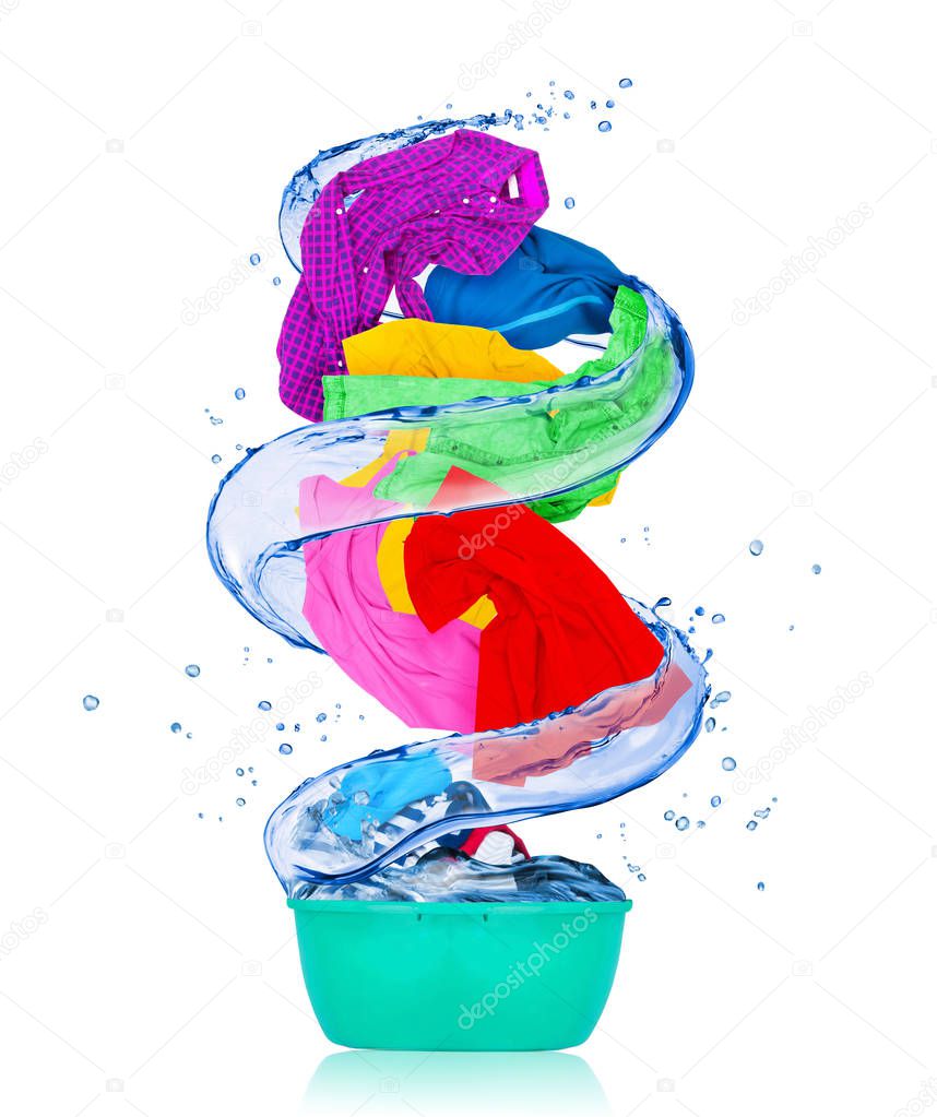 Colorful clothes rotates in a swirl and flying out from bowl