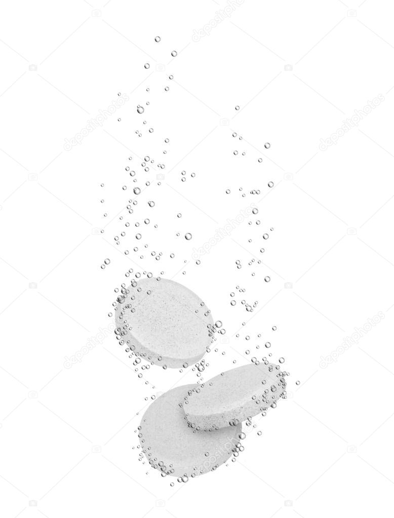 Three medical pills dissolves in water, isolated on white 