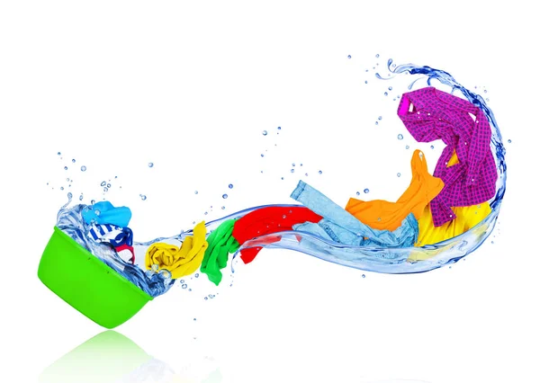 Bright colorful clothes flying out from wash bowl with water — Stock Photo, Image