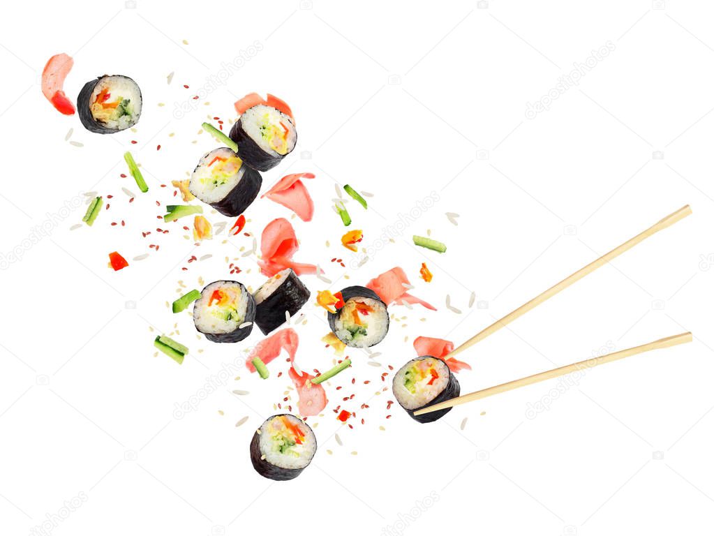 Pieces of sushi fly in the air on a white background