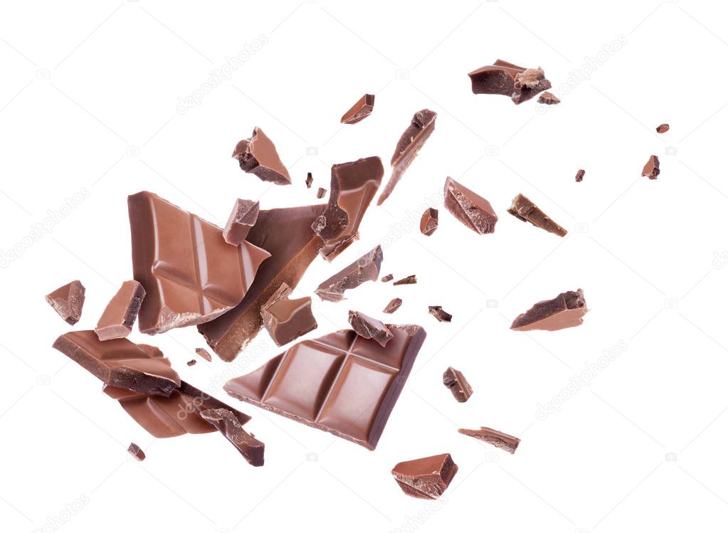 Chocolate broken into pieces in the air, isolated on a white background