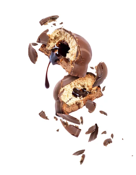 Chocolate cake broken into pieces in the air, isolated on a white — Stock Photo, Image