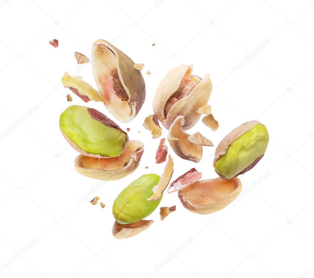 Pistachio crushed into pieces, frozen in the air close-up