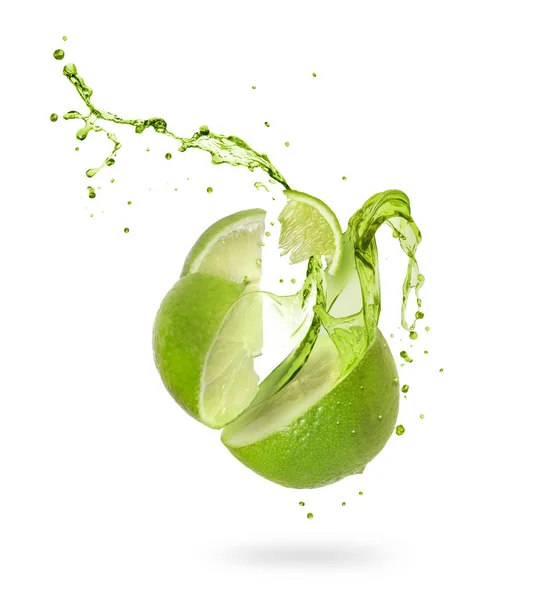 Juice splashes out of a cut lime on a white background — Stock Photo, Image