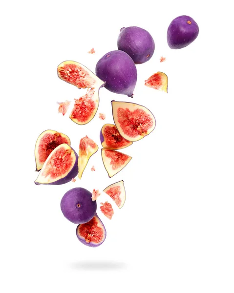 Whole and sliced ripe figs in the air, isolated on a white background — Stock Photo, Image