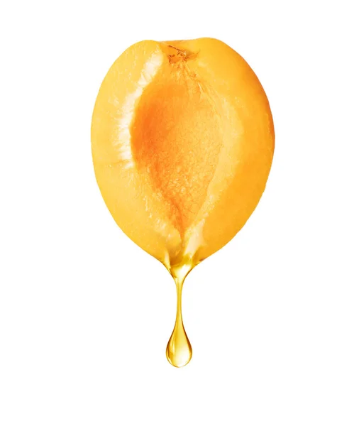 A drop dripping from a half of apricot isolated on white background — 스톡 사진