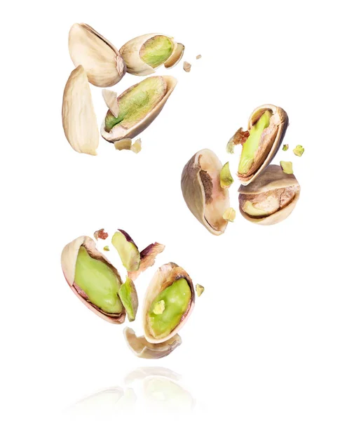 Group of crushed pistachios in the air close-up on a white background — 스톡 사진