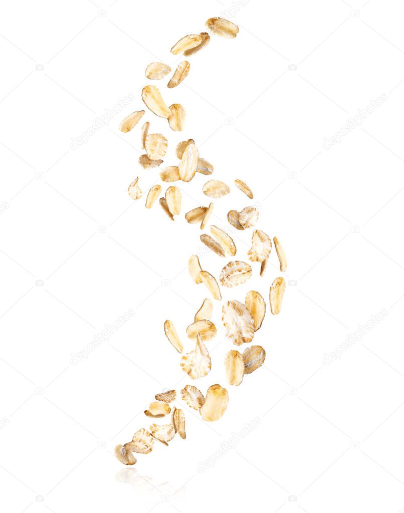 Oat flakes frozen in the air isolated on a white background