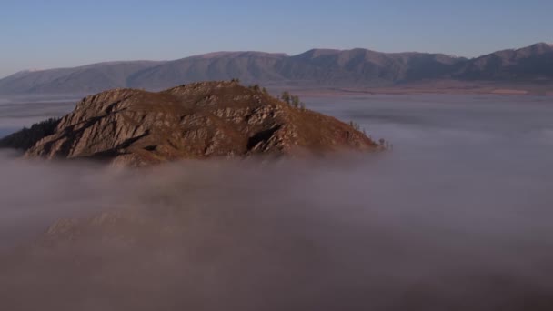 Aerial view At Dawn Over the mountain Above the clouds in the Fog. — Stock Video