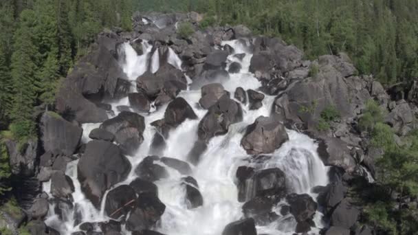 Flyg närmar sig ett stenigt vattenfall. Utsikt över dalen med en mäktig flod faller ner. 4k — Stockvideo